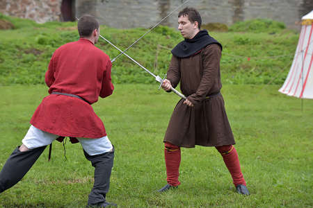 Russia, Ivangorod 01.08,2015 Festival of medieval reconstruction "Russian fortress", Fencing on swords in medieval costumesのeditorial素材