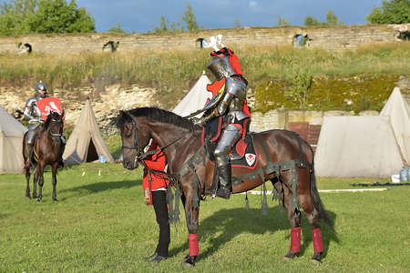 Russia, Ivangorod 01.08.2005 Festival of the medieval reconstruction "Russian fortress". Riders on horseback in the tournamentのeditorial素材