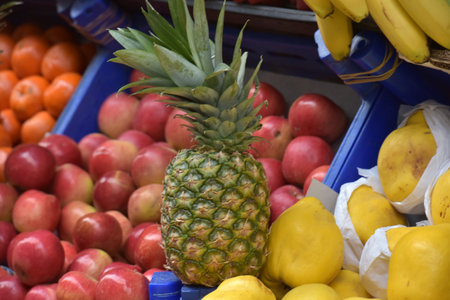 pineapple, apples and tangerines in the vegetable market