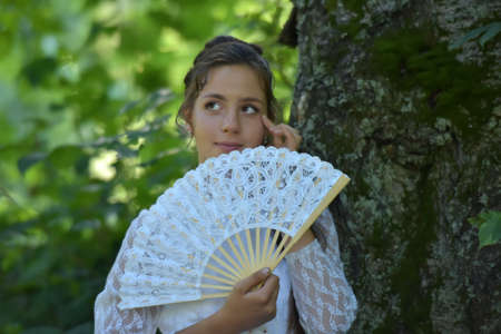 girl in white dress with fan hands onの写真素材