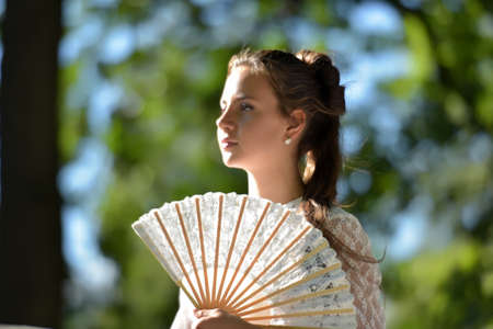 girl in white dress with fan hands onの写真素材