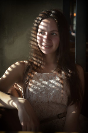 beautiful smiling teen girl and strips of sunlight