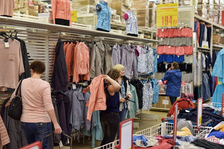 Russia, St. Petersburg, 15,03,2015 Buyers measure clothes in the supermarket