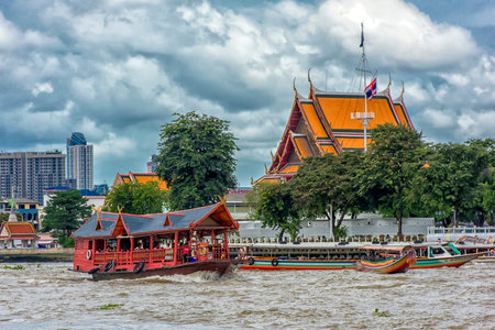 Thailand, Bangkok 20,08,2018 Traditional wooden boat with restaurant on the Chao Phraya river cruising tour.のeditorial素材