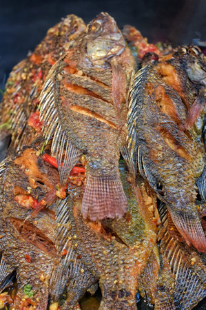 Salted fish on a charcoal grill.