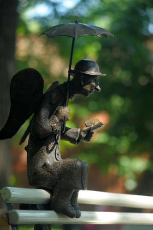 ST. PETERSBURG, RUSSIA - 21.06.2013: A sculpture "The St. Petersburg angel" on a bench in the Izmaylovsky gardenのeditorial素材