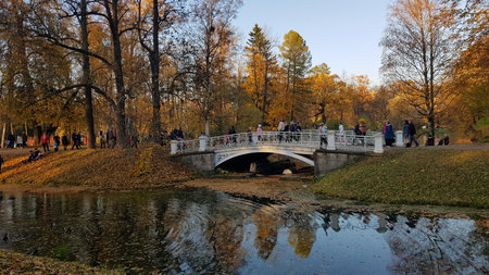 Russia, Pushkin, 14,10,2018 Autumn Park with an island and canals and people walking