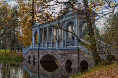 Russia, Tsarskoye Selo, 14,10,2018  Marble bridge in autumn foliage in Catherine park (Pushkin), St. Petersburg, Russiaのeditorial素材