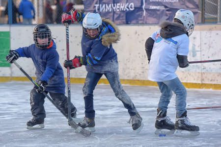 Russia, Severodvinsk 27,11,2016 Children with hockey sticks playing hockey at the festival "Hockey Day" outdoor street festivalのeditorial素材