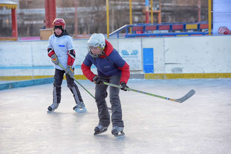 Russia, Severodvinsk 27,11,2016 Children with hockey sticks playing hockey at the festival "Hockey Day" outdoor street festivalのeditorial素材