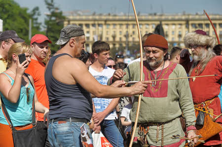 Russia, St. Petersburg 24,05,2014 People in medieval clothes shoot from a bow at the festival of historical reconstruction "Norwegian Vikings"のeditorial素材