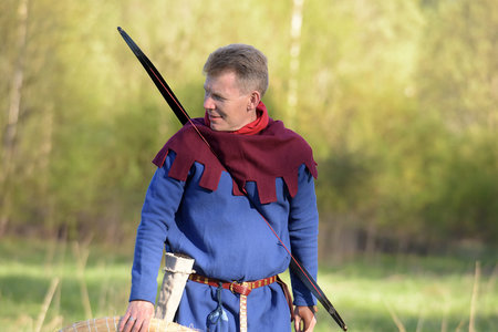 Russia, Svargas 24,05,2014 People in medieval clothes shoot from a bow at the festival of historical...