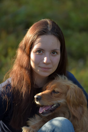 teen girl in forest with dog spaniel