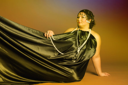 woman in oriental robes in black with pearls around her neck