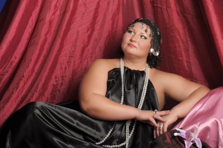 woman in Oriental clothes lies on pillows