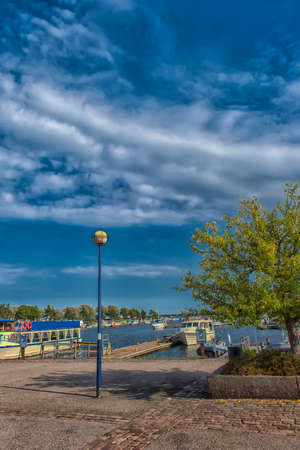 Finland, Kotka 17,08,2019 Tree on the Kotka embankment and yachts at the marinaのeditorial素材