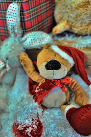 Christmas toy bear in a hat with decorationsの写真素材