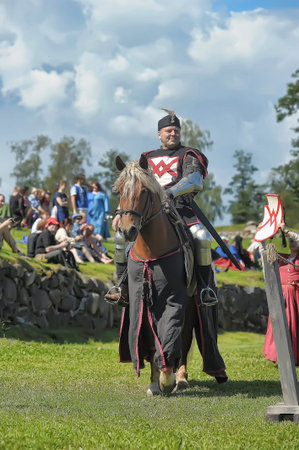 Russia, Priozersk 06.07.2014 A knight with a spear on a horse at the Russian Fortress festival of...