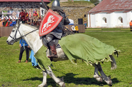 Russia, Priozersk 06.07.2014 A knight with a spear on a horse at the Russian Fortress festival of...