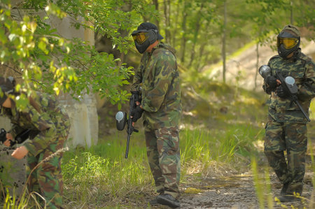 St. Petersburg, RUSSIA 20.06.2014 Open-air paintball tournament at the end of summer in nature, People in camouflage, with paintball guns and masksのeditorial素材