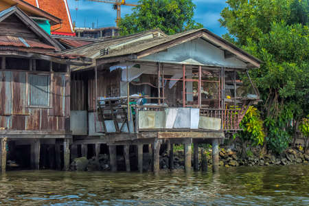 Photo for Thailand, Bangkok, 06.07.2019 Riverside slums & Fishermen Life in Chao Phraya River - Royalty Free Image