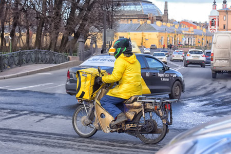 Russia, St. Petersburg 30.03.2020 Empty streets and food delivery couriers in the city center during...