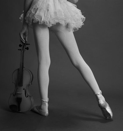 legs of a girl in ballet pointes and a violinの写真素材