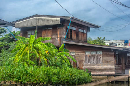 Bangkok, Thailand, 16,07,2019 - Wooden houses built in Chao Phraya river, Old wooden housesのeditorial素材