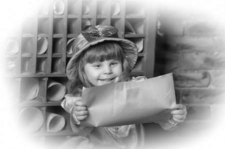 little girl in a hat and a blouse with pants in a vintage interiorの写真素材