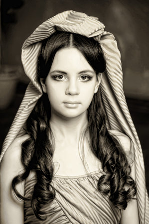Young victorian lady in a blue cape on her head