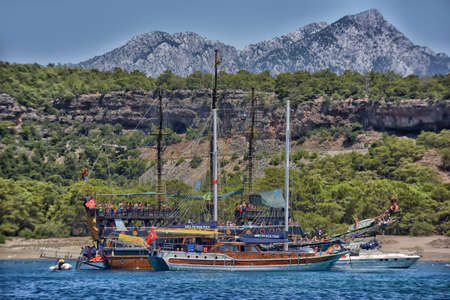 Antalya, Turkey 08/18/2016 Vintage wooden pirate schooner in the open ocean against the background of the sea horizon. Tourist cruises in the Mediterranean on old ships in Alanya (Turkey).のeditorial素材