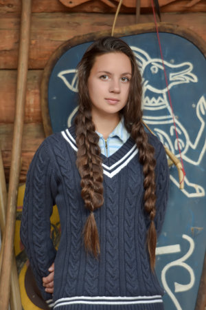 young beautiful russian brunette girl with braids outdoorの写真素材