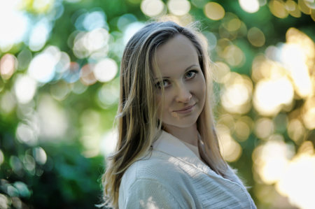 portrait of 30 year old blonde woman in park
