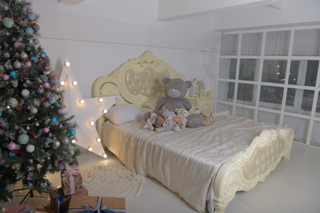 Christmas tree and bed with stuffed toys on it