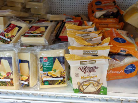 Russia, St. Petersburg 04.01.2021 Packages of cheese on sale on supermarket shelvesのeditorial素材