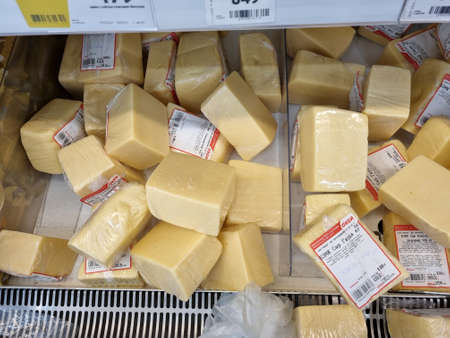 Russia, St. Petersburg 04.01.2021 Packages of cheese on sale on supermarket shelvesのeditorial素材