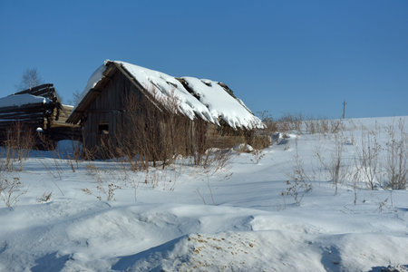 Russia, Izhevsk 28,02,2021 Wooden house in the Russian village in winterのeditorial素材