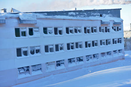 Russia, Vorkuta 02/14/2021 high snowdrifts in winter and an abandoned school buildingのeditorial素材