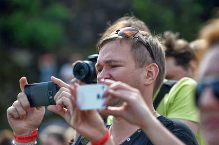 Russia, St. Petersburg 30.05.2016 Photographers and spectators with cameras at the festival "Motor Show"のeditorial素材