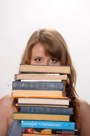 beautiful blonde student in the studio among the many books