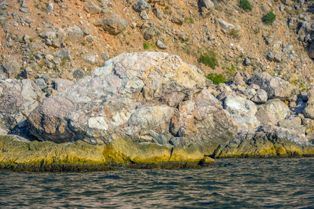 Beautiful view from water at yellow and orange Crimean mountain landscape near Balaklava at sea coastの写真素材
