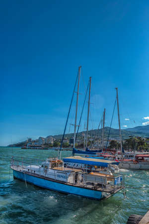 Crimea, Yalta - 05/19/2021 Yachts at the pier. Private yachts at the seafront of Yalta.のeditorial素材