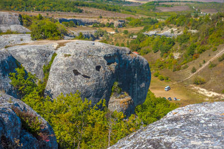 Ancient stone caves in a town-fortess Eski-Kermen high in a rocky mountains, Crimea. Top view.の写真素材