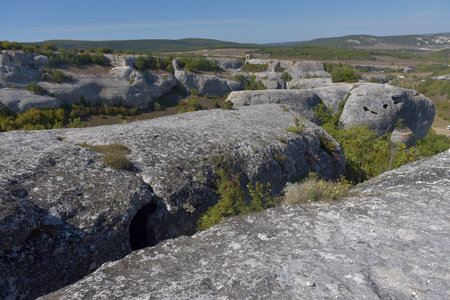 Ancient stone caves in a town-fortess Eski-Kermen high in a rocky mountains, Crimea. Top view.