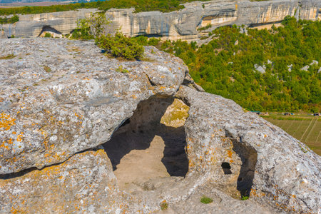 Ancient stone caves in a town-fortess Eski-Kermen high in a rocky mountains, Crimea. Top view.の写真素材
