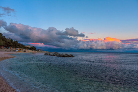 beautiful pink and lilac clouds sunset over the sea
