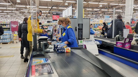 Russia, St. Petersburg 13,11,2021 Customer service in a supermarket during the coronavirus epidemic