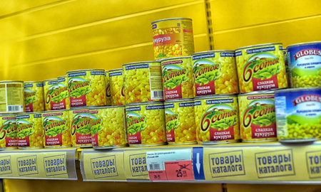 Russia, St. Petersburg 20,11,2021 Canned corn on a shelf in a supermarketのeditorial素材