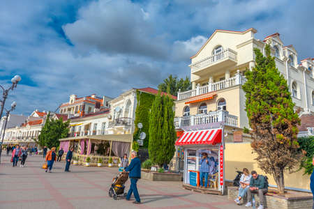 Balaklava, Sevastopol, Crimea - 09/20/2021: People stroll along the Nazukin embankment. Sunny day. Black seaのeditorial素材