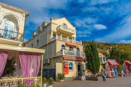 Balaklava, Sevastopol, Crimea - 09/20/2021: People stroll along the Nazukin embankment. Sunny day. Black seaのeditorial素材